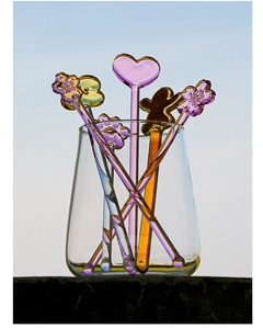 Rainbow glass stir sticks set with heart, flower, and gingerbread man shaped toppers