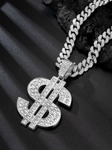 Close-up of silver Cuban link chain with rhinestone-encrusted dollar sign pendant