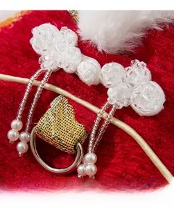 Detail of red chenille pet dress with crystal buttons and elegant pearl tassels