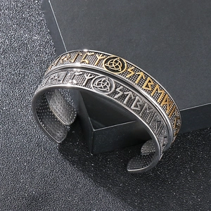 Detailed view of Viking cuff bracelets with Nordic runes and Celtic knot engravings