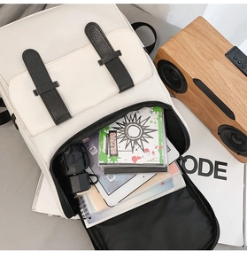 Internal view of a large cream backpack showing storage for laptop, umbrella and books