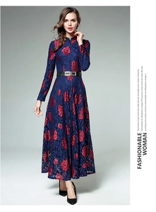 Detail of long-sleeve lace maxi dress featuring red floral embroidery and a slim belt