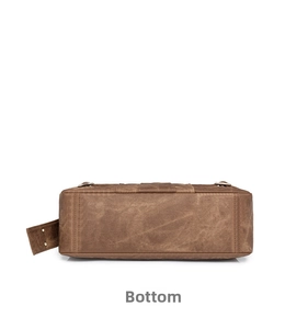 Detailed bottom view of brown PU leather bag with durable double stitching and studs