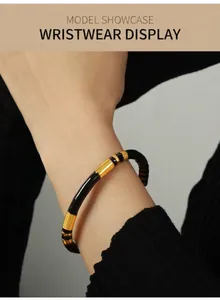 Detail of chic black and gold titanium steel bangle with elegant weight-style design