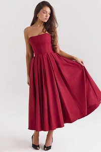 Close-up of a deep red strapless corset dress with full flowy skirt and satin texture
