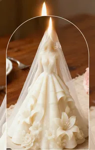 Detailed view of white wedding dress candle with intricate floral carvings and lace veil