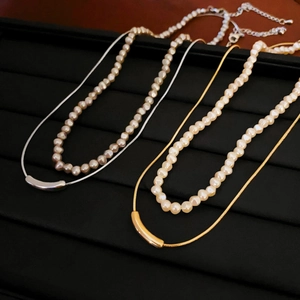 Double layered necklace set with baroque pearls and arc metal pendant in gold and silver