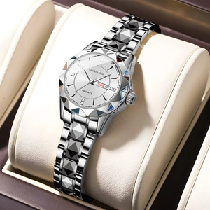 Detailed macro of silver quartz watch with diamond accents and date on a leather pillow