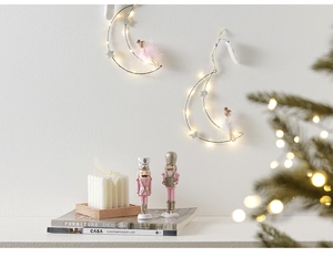 Close-up of moon-shaped LED iron pendant with star ornaments and a soft fairy doll