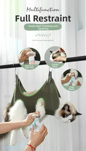 Detail of dark green cat grooming hammock kit with nail clipper and grooming tools