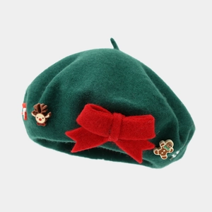 Detail of green wool Christmas beret with a red bow and festive reindeer charms