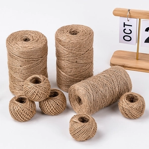 Natural jute twine rolls for cake decoration and gift wrapping on white background