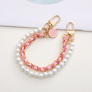 Double layered pearl and pink ribbon phone strap with camellia charm and gold clasps