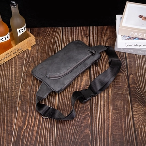 Matte dark gray leather chest bag with double zippers and black nylon strap for men
