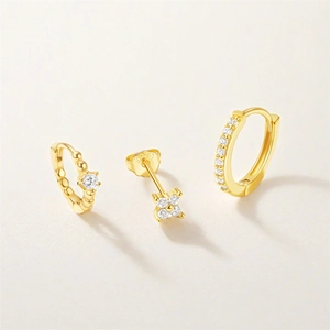 Detailed macro of gold plated s925 silver earring set with white zircon stones