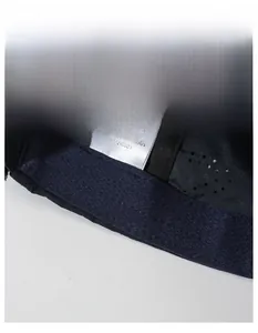 Detail of navy sun cap featuring breathable polyester fabric and wide sweatband