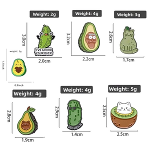 Detailed view of assorted creative avocado and cat enamel pins with size measurements