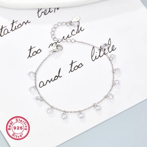 Macro detail of S925 sterling silver chain bracelet with clear faceted beads