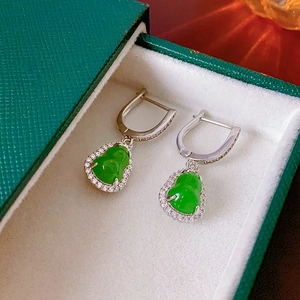 Macro detail of vintage zircon gourd earrings with green jade in a premium gift box