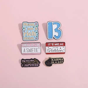 Detail view of 6 Taylor Swift inspired enamel pins with Swiftie lyrics and icons