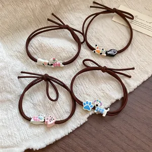 Cute set of four brown elastic hair ties with cartoon dog, cat, and fishbone charms