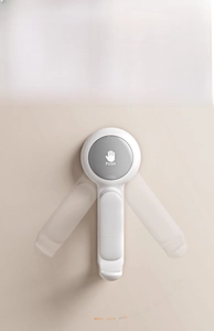Detail of the 360-degree rotating wall hook with gray PUSH button for washbasin storage