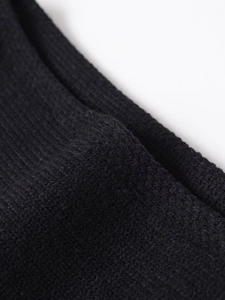 Macro shot of black ribbed knit fabric texture with soft fiber finish for winter wear