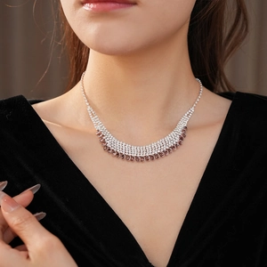 Detailed view of multi-row rhinestone fringe necklace with silver and bronze crystals