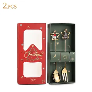 Close-up of golden Christmas spoons and forks with star pendants in a festive gift box