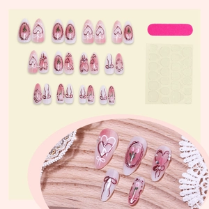 Pink gradient press-on nails with bow, heart, and tulip designs including 24pcs and glue kit