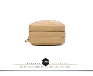 Bottom view of lightweight beige nylon crossbody bag with durable quilted stitching