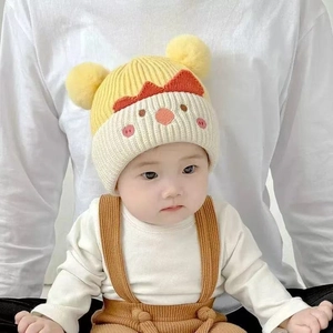 Cute baby knit beanie with cartoon chick design and yellow pom-poms for winter warmth