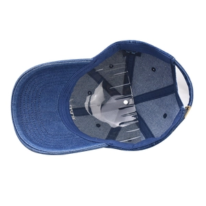 Internal structure of navy blue denim baseball cap showing adjustable strap and inner lining