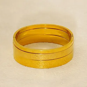 Set of three stackable 18K gold plated stainless steel bangles with hinged closures