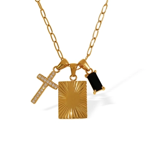 Gold paperclip chain necklace with black rectangle stone and cross pendant