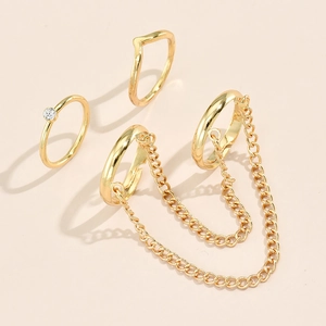 Detail of gold star and butterfly sequin rings set with rhinestone and chain link