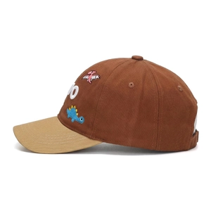 Close-up of cotton dinosaur embroidery and stitching on children's baseball cap