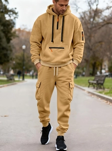 Detail of khaki men's hoodie set showing drawstring waistband and zipper pocket texture