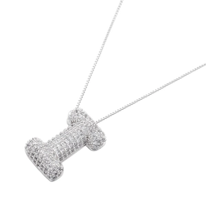 Macro view of silver color bubble letter I pendant with sparkling pavé zircons
