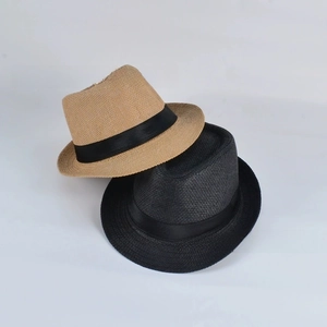 Detail of stacked khaki and black straw panama hats with black ribbon bands for summer