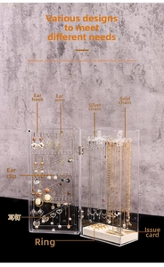 Detailed view of acrylic jewelry box showing multi-layer hooks for necklaces and earrings