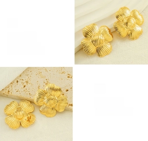 Detail showing polished gold flower earrings with intricate radial textures and plating