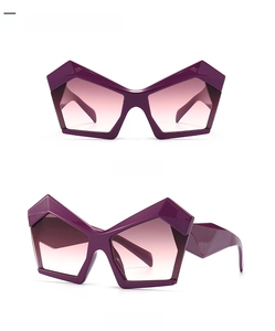 Trendy irregular geometric sunglasses with violet pink gradient lenses and thick frames.