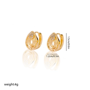 Detail of gold teardrop hoop earrings with pavé zircon and layered hollow design