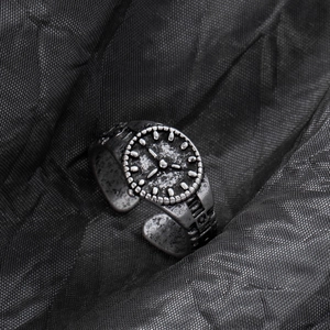 Close-up of vintage silver alloy watch-shaped adjustable open ring with retro finish