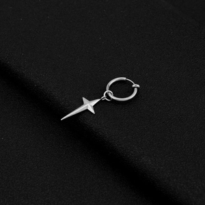Macro shot of silver stainless steel hoop earring with a dangling star pendant
