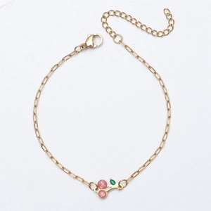 Detail of 18K gold-plated chain bracelet with pink glitter cherry pendant and lobster clasp