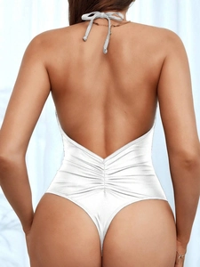 Detailed back view of metallic white halter swimsuit featuring a high-cut thong and open back