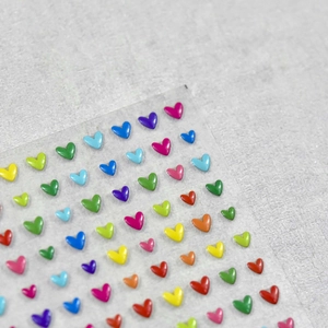 Macro detail of 3D heart-shaped jelly stickers in vibrant colors for nail art and DIY