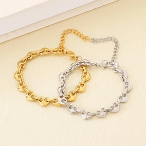 Detail view of heart link bracelets in gold and silver finish with adjustable lobster clasp